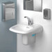 A white bathroom sink with a silver faucet and a WizKid Clean Current air freshener.