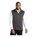 A man wearing a Port Authority graphite fleece vest.