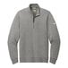 A grey Nike Dri-FIT half-zip sweater with a white swoosh.