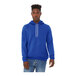 A man wearing a Bella + Canvas blue sponge fleece pullover hoodie.