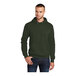 A man wearing an olive Port & Company fleece pullover hoodie with a hood.