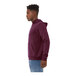 A man wearing a maroon Bella + Canvas sponge fleece pullover hoodie.