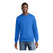 A man wearing a Port & Company royal blue core fleece crewneck sweatshirt.