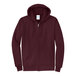 A maroon Port & Company zip up hoodie.