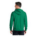 A man wearing a green Port & Company fleece full-zip hoodie.