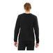 A man wearing a black Bella + Canvas Sponge Fleece sweatshirt with white raglan sleeves.