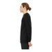 A man wearing a black Bella + Canvas raglan sweatshirt.