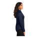 A Port Authority navy quarter-zip sweatshirt for women with long brown hair.