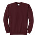 A maroon Port & Company core fleece crewneck sweatshirt.
