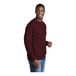 A man wearing a maroon Port & Company fleece sweatshirt.