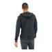 A man wearing a dark gray Bella + Canvas sponge fleece hoodie.