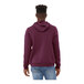 A man wearing a maroon Bella + Canvas sponge fleece pullover hoodie.