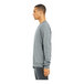 A man in an extra large Bella + Canvas grey raglan sweatshirt.