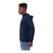 A man wearing a navy Bella + Canvas sponge fleece hoodie.
