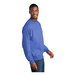 A man wearing a Port & Company heather royal blue sweatshirt.