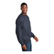 A man wearing a Port & Company heather navy sweatshirt smiling.