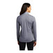 A woman wearing a Sport-Tek True Navy Heather quarter-zip pullover sweatshirt.