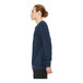 A man wearing a Bella + Canvas heather navy blue sweatshirt with blue sleeves.
