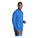 A man wearing a Port & Company royal blue fleece crewneck sweatshirt.