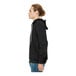 A person wearing a black Bella + Canvas sponge fleece full-zip hoodie.