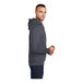 A man wearing a Port & Company heather navy fleece pullover hoodie.
