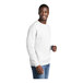 A man wearing a white Port & Company crewneck sweatshirt.