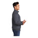 A man wearing a heather navy Port & Company quarter-zip pullover sweatshirt.
