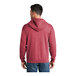 A man wearing a Port & Company heather red fleece full-zip hoodie.