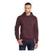 A man wearing a Port & Company heather athletic maroon pullover hoodie.