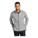 A man wearing a gray Port Authority fleece sweater jacket with a full zip.