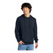 A man wearing a dark blue District sweatshirt with a hood.
