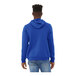 A man wearing a blue Bella + Canvas hoodie.