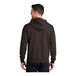 A man wearing a dark brown Port & Company full-zip hoodie.