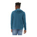 A man wearing a Bella + Canvas heather deep teal hoodie.