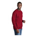 A man wearing a red Port & Company core fleece sweatshirt.