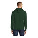 A man wearing a dark green Port & Company fleece pullover hoodie.