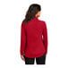 A woman wearing a Port Authority red quarter-zip sweatshirt.