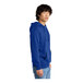 A person wearing a deep royal blue District hoodie.