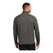 A man wearing a Port Authority gray quarter-zip sweatshirt.
