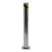 A close up of a stainless steel safety bollard with a yellow and black stripe.