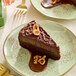 A slice of chocolate cake on a plate with American Almond Chocolate Hazelnut Spread.