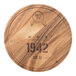 An Ironwood round acacia wood serving board with 1942 wine barrel engraving.