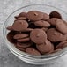 A bowl of chocolate coated cookies with Ghirardelli Dark Coating.