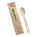 A compostable bamboo spoon and its individual paper wrapper.