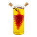 A clear glass cruet with a yellow liquid inside.