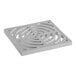 A white square PVC drain grate with a circle and spiral design.