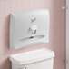 A white Scott toilet seat cover dispenser on a white toilet.