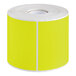 A roll of chartreuse rectangular labels.