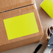 A cardboard box with a yellow sticker on it.