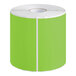 A roll of green rectangular paper labels with white edges.